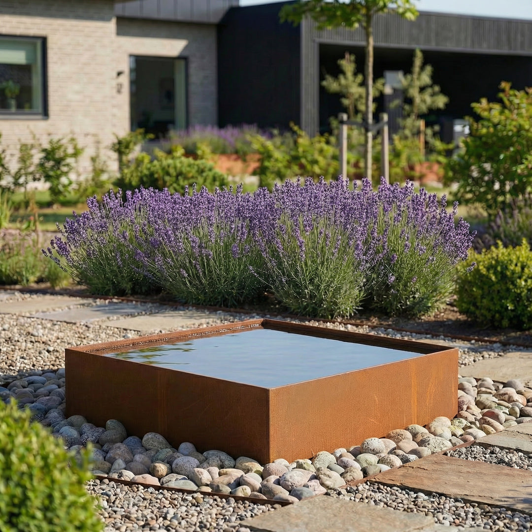 Mooi spiegelbassin van cortenstaal in een gezellige tuin